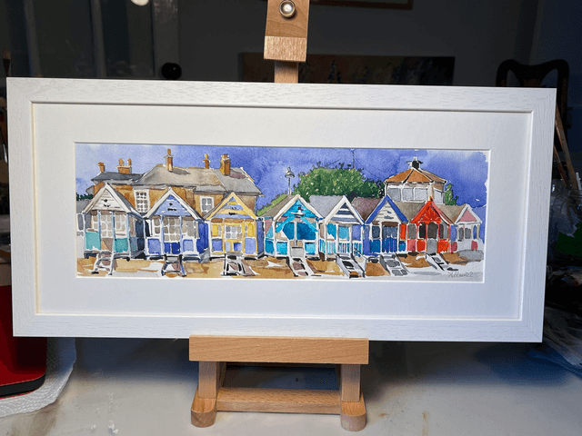 Southwold beach hats under Gunhill. Watercolor in a frame. Original art